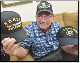  ?? Dan Watson/The Signal ?? Veteran Juan Rivera Ortiz, a native of Puerto Rico who served in the U.S. Merchant Marine, displays hats he received for service during World War II and the Korean War. Ortiz, now 90 years old, served aboard several ships during his years in the Merchant Marine.