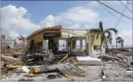  ?? ALAN DIAZ — THE ASSOCIATED PRESS ?? In this photo, debris surrounds a destroyed structure in the aftermath of Hurricane Irma in Big Pine Key, Fla. Rising sea levels and fierce storms have failed to stop relentless population growth along U.S. coasts in recent years, a new Associated...