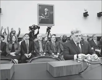  ?? ANNA MONEYMAKER/AFP ?? People in the gallery protest as Mark Milley, former chairman of the joint chiefs of staff, awaits the start of a hearing on the US withdrawal from Afghanista­n in 2021 on Tuesday in Washington, DC.