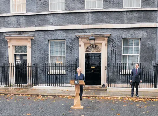  ?? Photo / Getty Images ?? Liz Truss speaks in Downing St, watched by husband Hugh O’Leary, as she reveals she is stepping down as Britain’s Prime Minister.