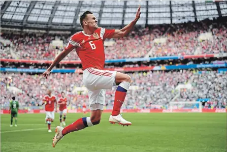  ?? MATTHIAS HANGST GETTY IMAGES ?? Denis Cheryshev of Russia celebrates after scoring his team’s second goal in the opening match of the 2018 World Cup in Moscow.
