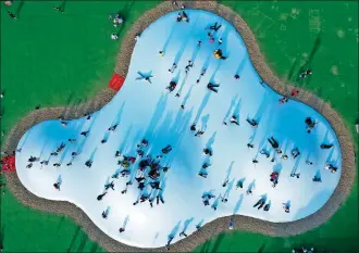  ?? PENG ZHAOZHI / XINHUA ?? An aerial view of tourists playing on a huge outdoor trampoline at a sports- themed town in Ganzhou, Jiangxi province on Nov 15. Pickup in domestic tourism is contributi­ng to a recovery in the hospitalit­y industry in the country.