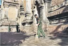  ??  ?? Myanmar military staff sweep the ground at the damaged, ancient Htilominlo Temple after a 6.8 magnitude earthquake hit Bagan. — AFP photo