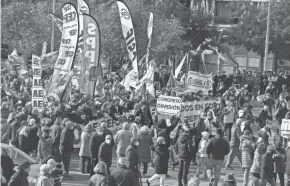  ?? PAUL WHITE/AP ?? Police march in Madrid on Saturday to protest against government plans to reform a controvers­ial security law known by critics as the “gag law.”