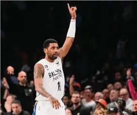  ?? Mary Altaffer / Associated Press ?? Nets guard Kyrie Irving reacts after scoring a three-point basket during the second half against the Knicks on Saturday.
