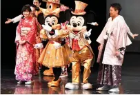  ??  ?? 20-year-old men and women draped in traditiona­l kimonos are celebrated by Mickey Mouse (second right) and Minnie Mouse (second left) during their ‘Coming-of-Age Day’ ceremony.