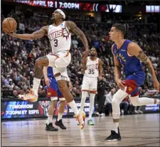  ?? AARON ONTIVEROZ — THE DENVER POST ?? Bradley Beal of the Phoenix Suns drives past Denver’s Michael Porter Jr. at Ball Arena on March 5.
