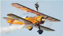  ?? DREAMSTIME / TNS ?? A wing-walker performs during an air show in Britain.