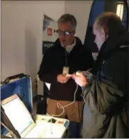  ?? KATHLEEN CAREY — DIGITAL FIRST MEDIA ?? Ron Clevenger, vice president of sales for Hart Intercivic, assists Joseph Sickora of Doylestown in using an accessible voting device for the blind.