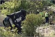  ?? MARCIO JOSE SANCHEZ / AP ?? Workers collect debris beside a vehicle after a rollover accident on Feb. 23 involving golfer Tiger Woods in Rancho Palos Verdes.