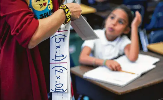  ?? Brett Coomer photos / Houston Chronicle ?? Fourth-grade teacher Gabriella Bogani works with her class at Jackson Elementary in Rosenberg. The Lamar CISD school jumped up from 405th to 148th in the annual rankings of the Children at Risk academic report card. The grades and rankings reflect a...