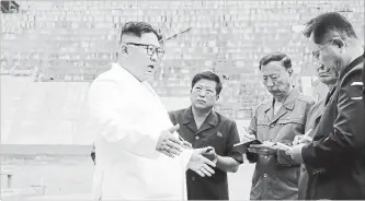  ?? THE ASSOCIATED PRESS FILE PHOTO ?? In this undated photo provided by the North Korean government, North Korean leader Kim Jong Un, left, inspects the constructi­on site of a hydroelect­ric power plant in North Hamgyong Province.