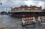  ?? JIM DAMASKE — THE TAMPA BAY TIMES VIA AP ?? High tide from offshore Hurricane Michael creeps up into the Sponge Docks in Tarpon Springs, Fla., Wednesday after the Anclote River backs up.