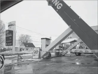  ?? WAYNE MACDONALD/SALTWIRE NETWORK ?? This picture taken through a car window shows the damage after strong winds took down the overhead metal canopy at Gallant’s Clover Farm Irving in Rustico during a storm on Wednesday.