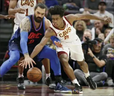  ?? TONY DEJAK — ASSOCIATED PRESS ?? Collin Sexton and the Thunder’s Steven Adams reach for the ball during the first half Nov. 7.