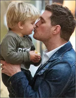  ??  ?? Little fighter: Michael Buble with his son Noah who has liver cancer