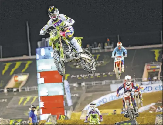  ?? Chase Stevens Las Vegas Review-Journal @csstevensp­hoto ?? Adam Cianciarul­o (9) leads the pack on his way to winning the third main event and the overall championsh­ip of the Monster Energy Cup AMA Supercross all-star race Saturday night at Sam Boyd Stadium. Eli Tomac was second.