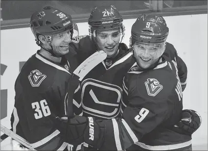  ?? LES BAZSO/ PNG ?? Vancouver Canucks Jannik Hansen ( left) and Mason Raymond congratula­te Cody Hodgson ( right) after he scored the winning goal on Saturday against the San Jose Sharks at Rogers Arena. Hodgson is now fourth overall in NHL rookie scoring this season.