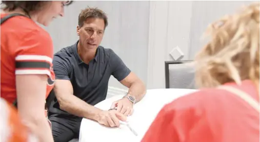  ?? ANNIE RICE/AP ?? Former Hawks captain Chris Chelios was among the alumni signing autographs at the Hawks Convention on Friday. The event continues through Sunday.