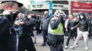  ??  ?? Gardai force back protesters during the anti-lockdown protest in Dublin city centre