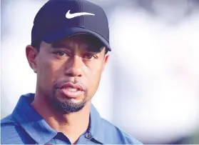  ?? AP FOTO ?? LITTLE PLEASURES. Tiger Woods says riding a cart brought him pain before his fourth surgery.