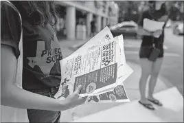  ??  ?? Anna Ruiz, an intern with Project South, hands out informatio­n Saturday about civil rights in an Atlanta-area neighborho­od that’s home to many South Asians.