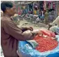  ?? APP ?? A street vendor is arranging pomegranat­es as he waits for customers at a market in Rawalpindi on Thursday. —