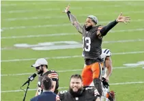  ?? RON SCHWANE THE ASSOCIATED PRESS FILE PHOTO ?? Browns wide receiver Odell Beckham Jr. (13) jumps behind Baker Mayfield after they defeated the Indianapol­is Colts on Sunday in Cleveland. Beckham Jr. was sent home feeling ill Thursday.