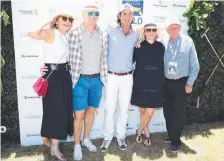  ??  ?? Katie Page-Harvey, Mike Tindall, Nacho Figueras, Zara Phillips and Gerry Harvey pose for photograph­ers.