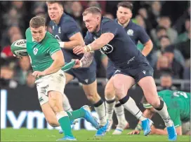  ??  ?? New Scotland captain Stuart Hogg attempts to gettogrips with Ireland’s Jordan Larmour in Dublin