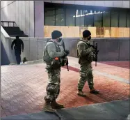  ?? (AP/Jim Mone) ?? National G uard m em bers maintain security Tuesday near the loading dock of the barricaded Hennepin County Government Center in Minneapoli­s, where jury selection is underway in the trial of former police officer Derek Chauvin.