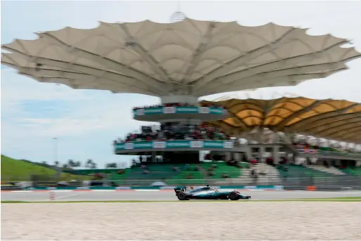  ?? AFP ?? Lewis Hamilton drives his Mercedes on his way to securing pole position of the Formula One Malaysia Grand Prix in Sepang on Saturday. —