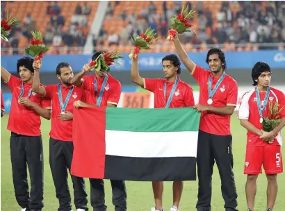  ?? AFP file ?? Members of the UAE team acknowledg­e the crowd after losing the 2010 Asian Games final to Japan. —