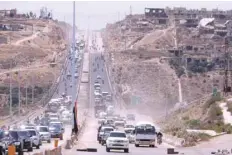  ??  ?? Vehicles travel on the road between Homs and Hama during its re-opening in Rastan, Syria, on Wednesday. — Reuters