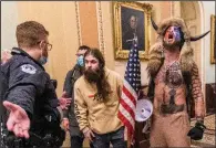  ?? (AP/Manuel Balce Ceneta) ?? Jacob Chansley (right) and other rioters are confronted by U.S. Capitol Police officers outside the Senate chamber on Jan. 6. Chansley, who pleaded guilty to a felony charge of obstructin­g an official proceeding, was among the first rioters to enter the building.