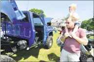  ?? Alex von Kleydorff / Hearst Connecticu­t Media ?? Emmett Holly, 3, rides on his father Kevin’s shoulders while taking a look at all the cars, including a monster truck displayed at the 4th annual New England Auto Museum Father’s Day Car Show in Mathews Park in Norwalk on Sunday. A major fundraiser for the museum, the event attracted more than 100 cars that spread out on the lawn with the Lockwood-Mathews Mansion as a backdrop.