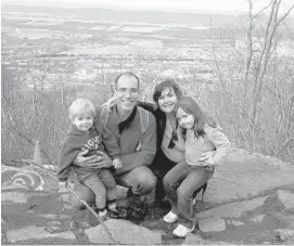  ?? CAROLINA BASTIDAS/COURTESY ?? Carolina Bastidas, her husband Luis, and children Rafael and Andrea in December 2011, days after arriving from Venezuela. State College, Pa., in the background, was their first home. They became U.S. residents under the Cuban Adjustment Act.