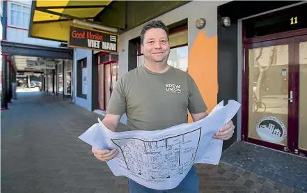  ?? MURRAY WILSON/STUFF ?? Brew Union and Libre co-owner Murray Cleghorn holds the plans for a new Mexican restaurant that will soon open on George St.