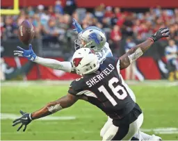  ?? ROB SCHUMACHER/THE REPUBLIC ?? The Lions’ Darius Slay intercepts a pass in front of the Cardinals’ Trent Sherfield. Slay returned the interecpti­on for a touchdown.