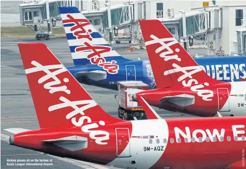  ??  ?? AirAsia planes sit on the tarmac at Kuala Lumpur Internatio­nal Airport.