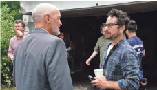  ??  ?? “Castle Rock” executive producer J.J. Abrams visits with his “Lost” star Terry O’Quinn, who plays Shawshank warden Dale Lacy in the new Hulu series.