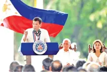  ??  ?? TRIBUTES: Philippine President Rodrigo Duterte, left, delivers an address while Vice President Leni Robredo, right, and Defence Secretary Delfin Lorenzana, center, look on at the National Heroes’ Cemetery as part of commemorat­ions for National Heroes’...