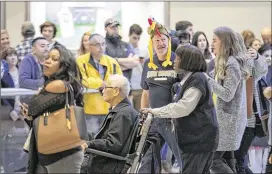  ?? BOB ANDRES / BANDRES@AJC.COM ?? Passengers head toward the baggage-claim area at Hartsfield-Jackson Atlanta Internatio­nal Airport. Officials recommend travelers arrive at the airport at least two hours before their scheduled departure. About 97,000 people will likely pass through security checkpoint­s on Sunday alone, they said.