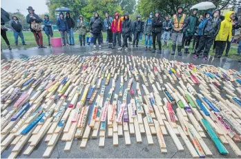  ?? JASON PAYNE ?? More than 2,000 stakes, many with names inscribed, representi­ng opioid overdose deaths were laid out at Oppenheime­r Park in the Downtown Eastside Friday as part of the Opioid Overdose Day of Action.