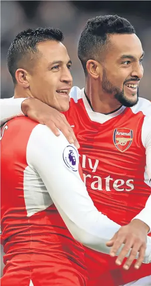  ??  ?? Alexis Sanchez (left) celebrates scoring with team-mate Theo Walcott.