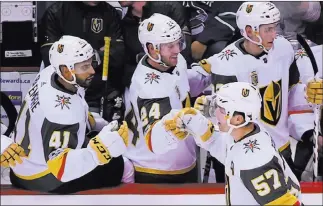  ?? Anne-marie Sorvin ?? USA Today David Perron (57) taps gloves with teammates after his goal in the first period on Thursday night.