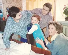  ??  ?? Conjoined twins Masha, left, and Dasha Krivoshlya­pova are seen with journalist and author Juliet Butler and her child, Sasha.