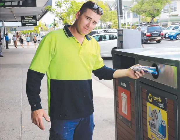  ?? Picture: JUSTIN BRIERTY ?? CONVENIENT LOCATION: Ryan Furney puts one of Cairns Regional Council’s newly installed bins, this one on McLeod St, to good use.