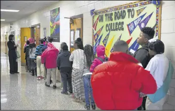  ?? PHIL SKINNER / SPECIAL ?? Students change classes at Flat Shoals Elementary School in DeKalb County. The school works hard to help low-income households in their district.