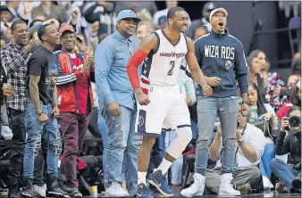  ?? [NICK WASS/THE ASSOCIATED PRESS] ?? Washington Wizards guard John Wall reacts to a play during the second half against the Boston Celtics, Sunday in Washington.
ROCKETS 125, SPURS 104: